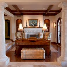 Column Framed Traditional Sitting Room With Wood Coffered Ceiling, Upholstered Tufted Bench and Patterned Armchairs 