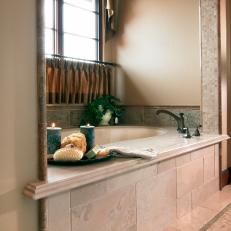 Traditional Bathtub With Decorative Tile Frame, Metallic Window Curtains and Neutral Color Scheme 