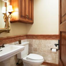 Neutral Bathroom With Decorative Textured Molding, Half Wall Marble Tile and Mounted Wood Cabinet 