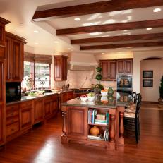 Spacious Traditional Kitchen With Exposed Wood Beams, Rich Wood Cabinetry and Eat In Island 