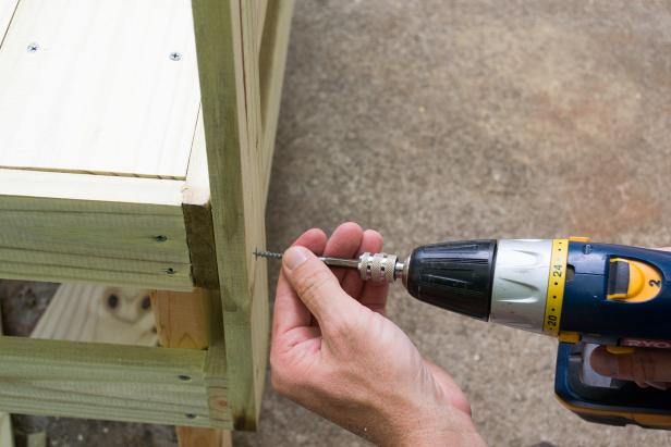 Attach the tool rack to the back legs, through the leg supports, with the bottom of the uprights lined up with the bottom edge of the lower leg supports. Using two-inch exterior screws.