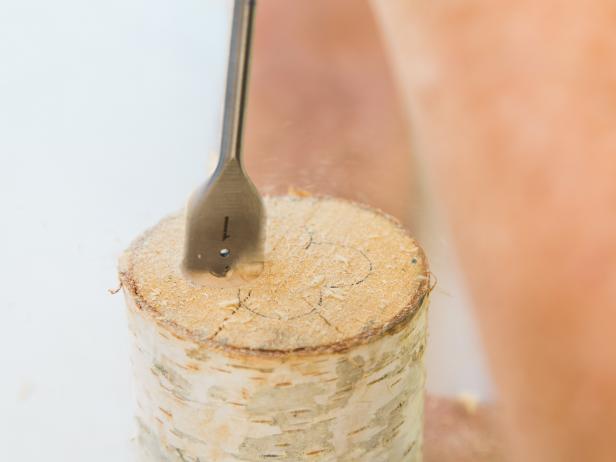 With a 1-inch paddle bit in your drill, begin drilling down an inch or so at the time on each of the four holes Then using a hammer, chisel out the center section left inside the log until your vase has the necessary depth . HINT: You really only need about 4 inches, depending on the size of your arrangement and log.
