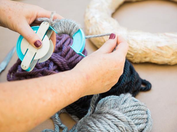 Creating a pom-pom is easy, whether you go “old school” and use your hand or use one of the little devices available at craft stores. If using a device, open one side, then wrap the yarn tightly around edge, pull yarn through to other side and repeat on the other edge.