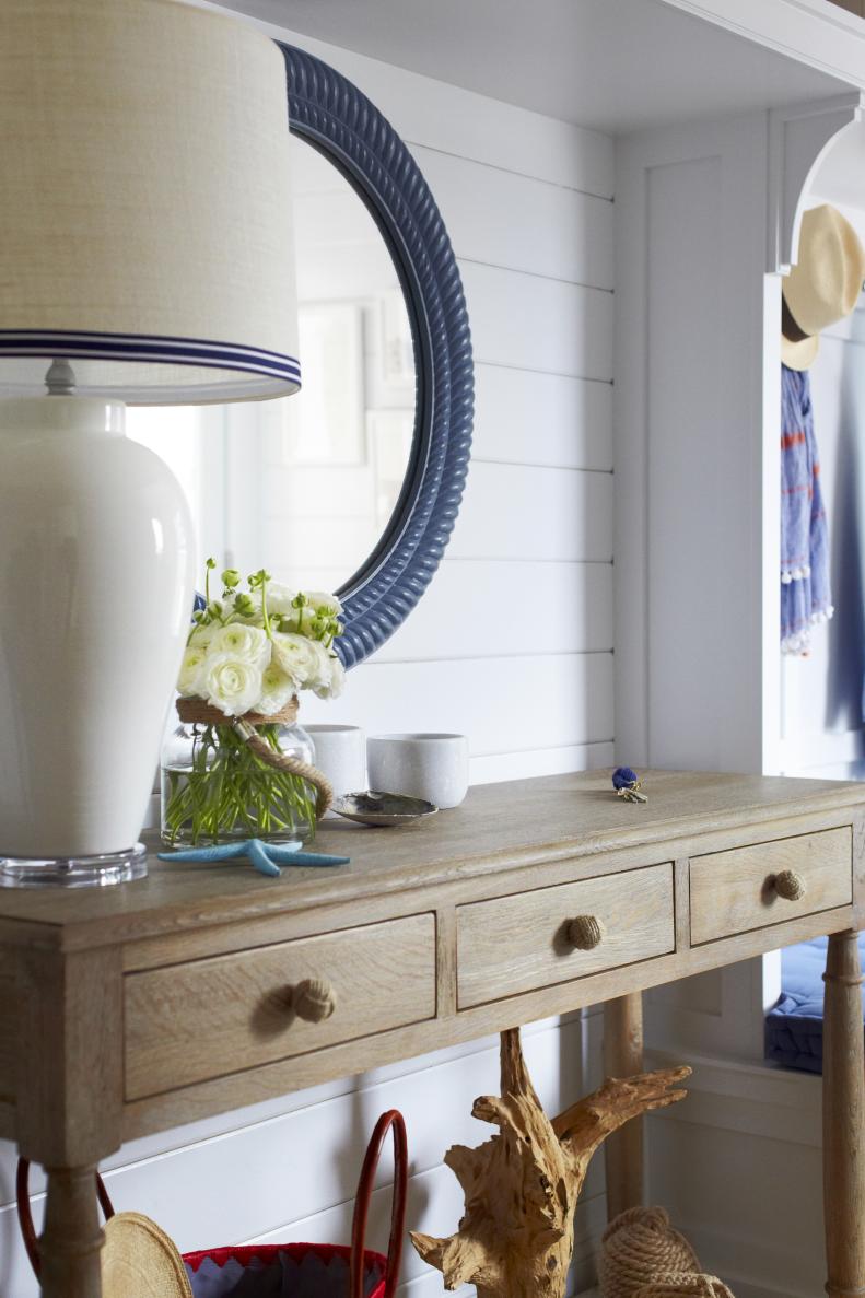 White Coastal Mudroom With Wood Console Table, White Lamp, Blue Mirror