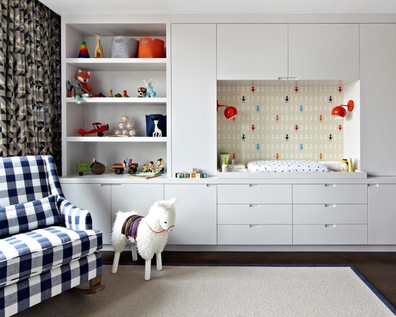 Boy's Nursery With White Built-In Cabinets and Changing Station