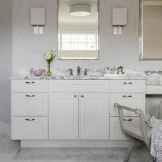 White Bathroom With Marble Backsplash and Floor