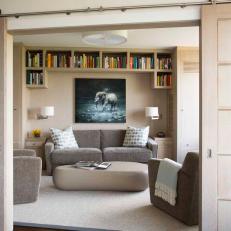 Modern Library Concealed by Barn Doors to Create a Reading Nook
