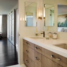 Bleached Oak Cabinetry in Master Bathroom Complements the Barn Doors in Master Bedroom 