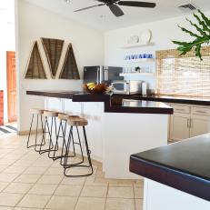 Waterfall Countertops and Wicker Wall Hangings in Beachy Open Plan Kitchen