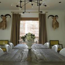 Rustic Table, Modern Chairs and Exotic Mounts Create Eclectic Dining Space