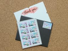 Stamps, a thank you note, and an envelope