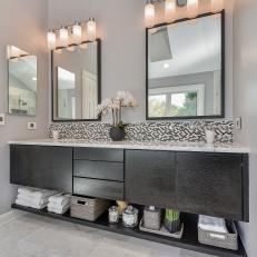 Contemporary Double Vanity With Sleek Black Base, Tiny Tile Black and White Backsplash and Four Bulb Sconce Over Mirrors