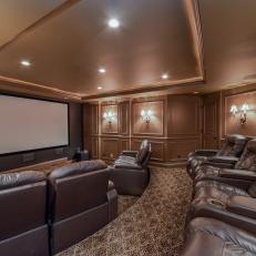 Large Home Theater With Plush Brown Leather Seats and Tray Ceiling With Recessed Lighting Over Patterned Carpet 