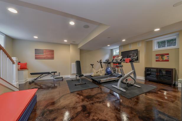 Basement Home Gym With Brown Stone Flooring Tray Ceiling