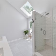 Monochromatic Contemporary Bathroom With Glass Door Walk in, Subway Tile Shower and Skylight 