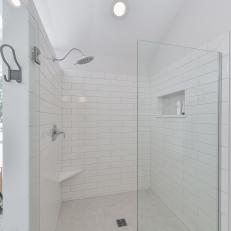 Glass Door Walk in Shower With White Subway Tile Walls, White and Gray Tile Floor and Stainless Steel Rain Shower Head 