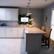 Breakfast Bar with Granite Countertop and Pendant Lighting in Remodeled French Country Kitchen