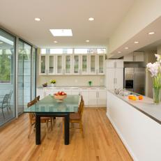 Cape Cod Kitchen and Dining Area With Sliding Door and Glass Table
