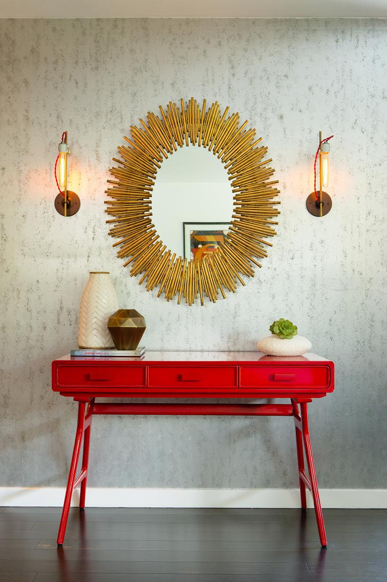 Red Console Table with Stick Framed Mirror and Wall Sconces