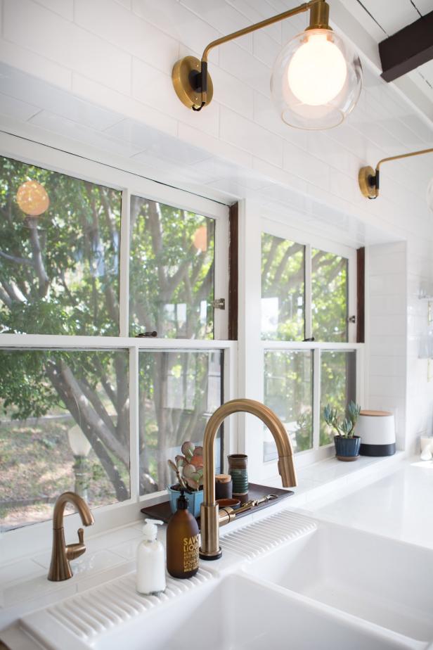 Brass Sconces and White Subway Tile Over Sink