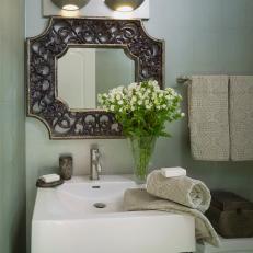 Traditional Powder Room With Ornate Vanity Mirror