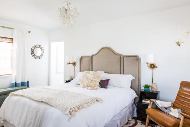 White Bedroom With Neutral Headboard and Leather Armchair