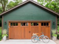 Green Garage With Carriage-Style Wooden Doors
