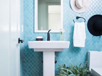 Black and White Sunhats on Blue Wall of Powder Room