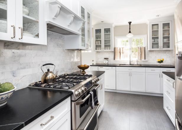 Kitchen With White Cabinets, Black Counters & Marble Backsplash