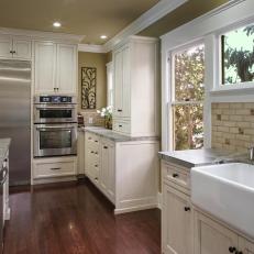Farmhouse Sink, White Cabinetry and Stainless Steel Refrigerator in Traditional Kitchen 