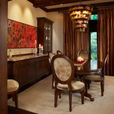 Formal Dining Room With Midcentury Modern Chandelier, Velvet Cushioned Dining Chairs and Long Buffet 