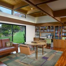 Spacious Study With Wood Rectangle Coffered Ceiling, Built in Bookshelf and Brown Leather Sofa 
