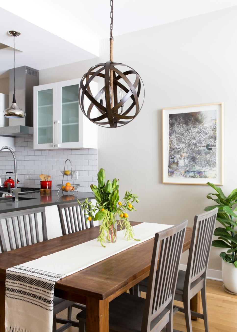 Modern Dining Room With Metal Strap Globe Chandelier and Yellow Flowers | HGTV