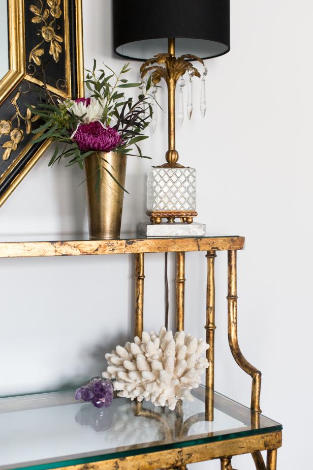 Gold Shelf With Palm Tree Table Lamp and Gold Flower Vase