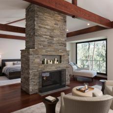 Stone Double Fireplace in Contemporary Master Bedroom