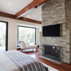 Statement-Making Stone Fireplace in Master Bedroom