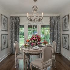 Transitional Dining Room With Crystal Chandelier and Floral Decor