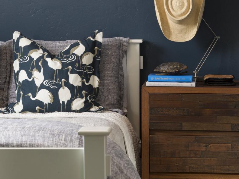 Navy Bedroom With Crane Print Pillow and Wooden Nightstand
