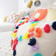 Girl's Bedroom With Colorful Pom Pom Throw Pillows