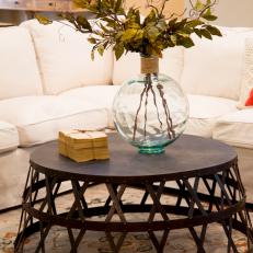 Industrial Coffee Table and Glass Vase Create Focal Point in Spacious Living Room