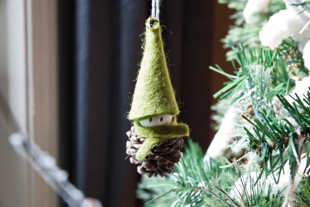 pine cone elf Christmas ornament hanging from tree