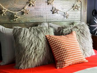 Headboard with twig, star garland and fur throw pillows