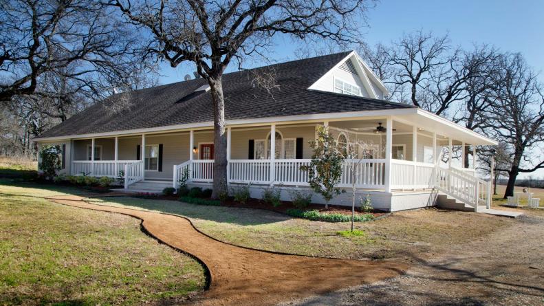 Fixer Upper Hosts Chip and Joanna Gaines transformed the exterior of the Mahan’s ranch-style home by painting the brick and siding a light gray and the wood trim bright white.   A new red double door, new railing, shutters, and landscaping help create a modern look, as seen on HGTV’s Fixer Upper.  After #2.  (after)