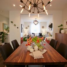 Midcentury Modern Dining Room Featuring Spider-Like Chandelier, Wood Table and Black Chairs 