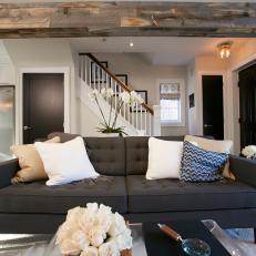 Tufted Sofa and Natural Wood Ceiling Beam in Sophisticated Contemporary Living Room 