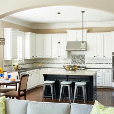 Transitional White and Black Kitchen with Pops of Blue and Archway
