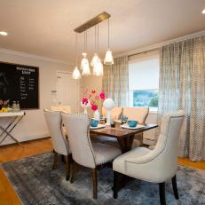 Nailhead Trimmed Chairs Surround a Pendant Chandelier in Family Friendly Contemporary Dining Room 
