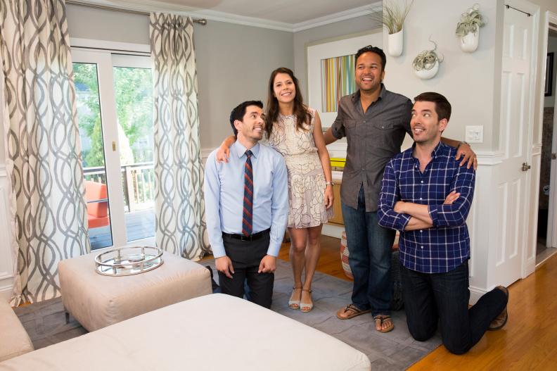 Hosts Drew (L) and Jonathan (R) Scott pose for a portrait with Marie Amato (center L) and Dennis Gupta (center R) in the sitting room of the couple's current home in Valhalla, New York, as seen on Buying & Selling. (Portrait)