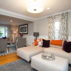 Cozy, Casual Sitting Room With Neutral Sectional, Accent Pillows and Upholstered Ottoman 