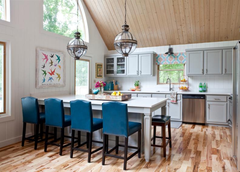 Vaulted Lakehouse Kitchen with White Walls, Gray Cabinets, Blue Chairs and Island